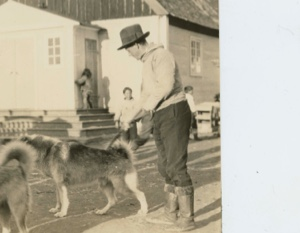 Image of Assistant Governor Rasmussen and dogs in front of church